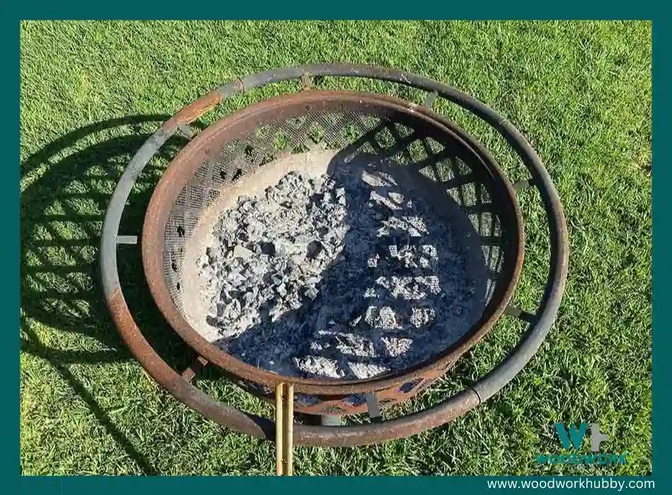 An image of a firepit with burnt wood.