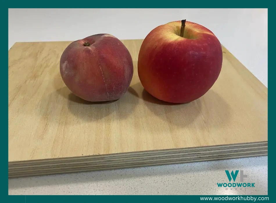 An image of two apples on a plywood.