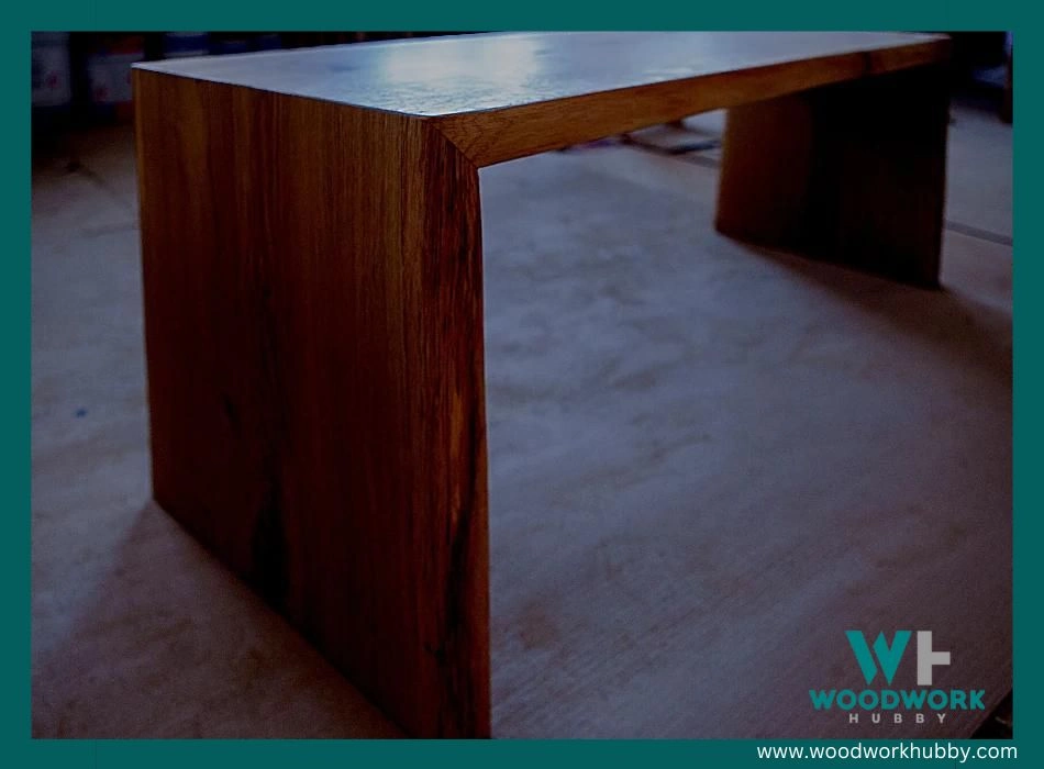 A newly treated wooden table with linseed oil placed in a dark area.