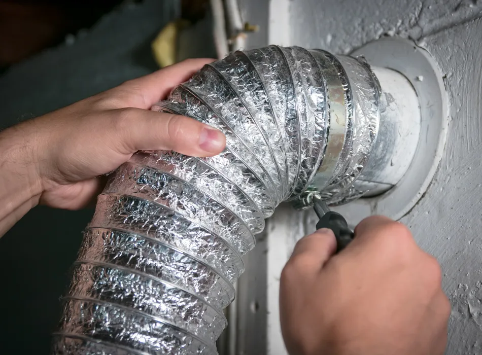 Image of hands holding a dryer vent hose