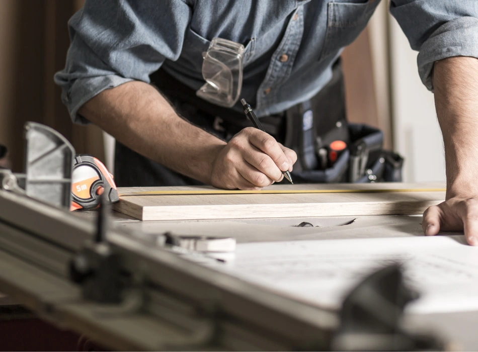 A man working on a wood on a  workbench