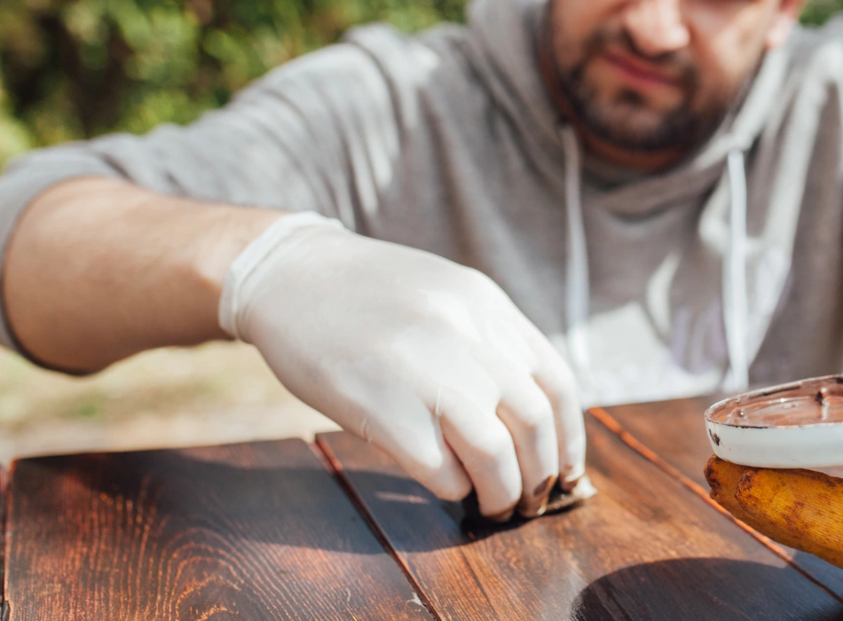 Will Linseed Oil Darken Wood Or Your Furniture? 20 A man polishing the wooden table