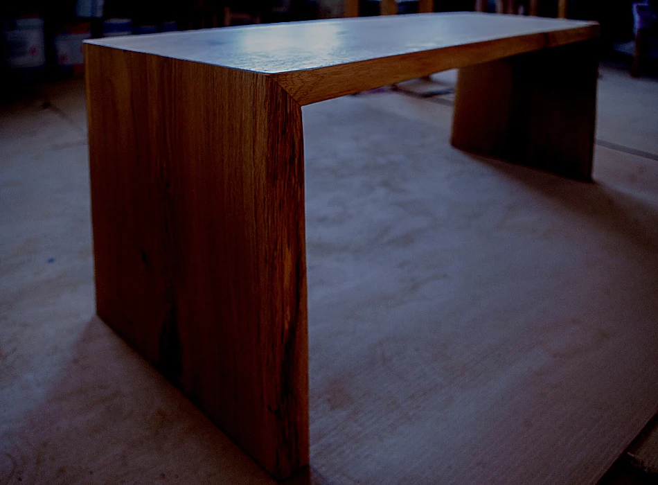 A newly treated wooden table with linseed oil placed in a dark area