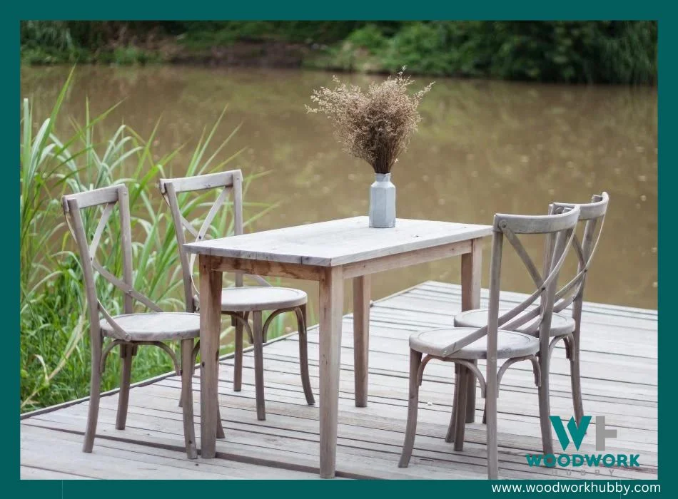 Wooden table and chairs on the deck near the river under the sun