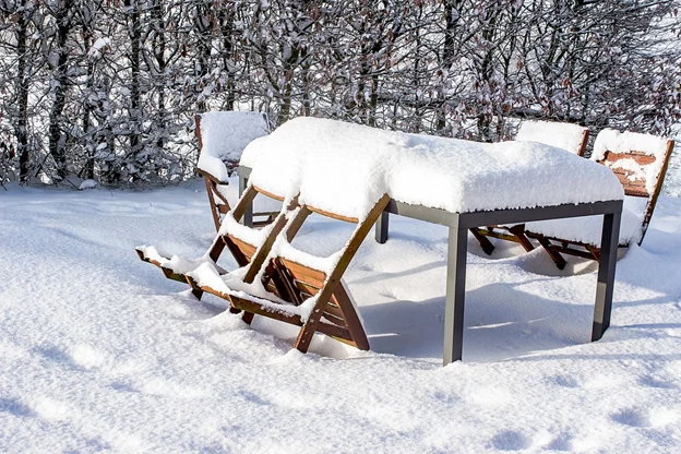 Outdoor furniture covered in snow