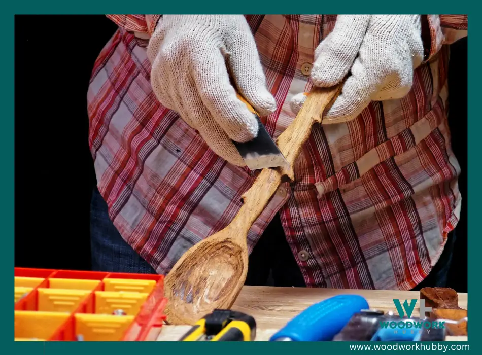 man carving a wooden spoon