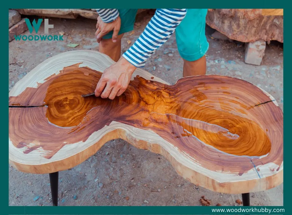 applying linseeed oil to a wooden table.